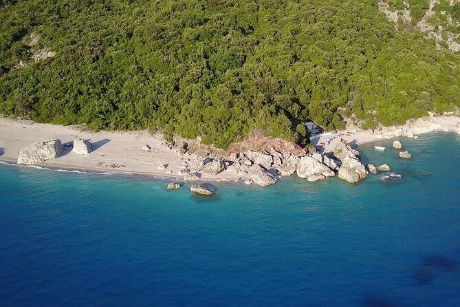Visit Kroreza Beach by Boat - Clear water, white shore, and high rocky hills